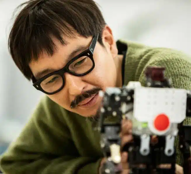 Engineer with dark glasses inspecting machinery