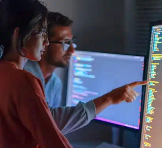Male and female coworkers sitting together and inspecting code
