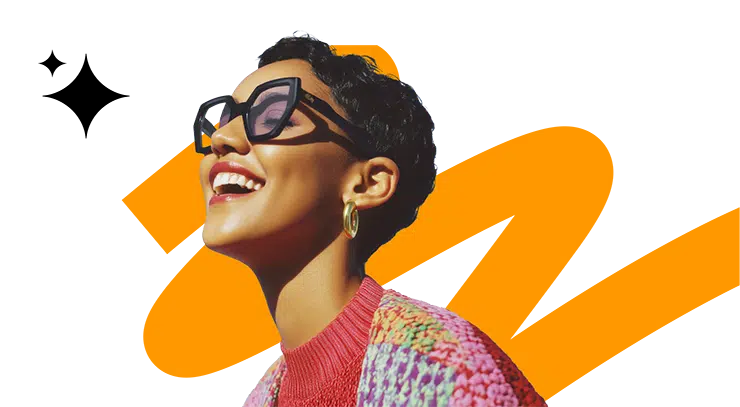 Young female professional with bold glasses and short hair smiling with her eyes closed