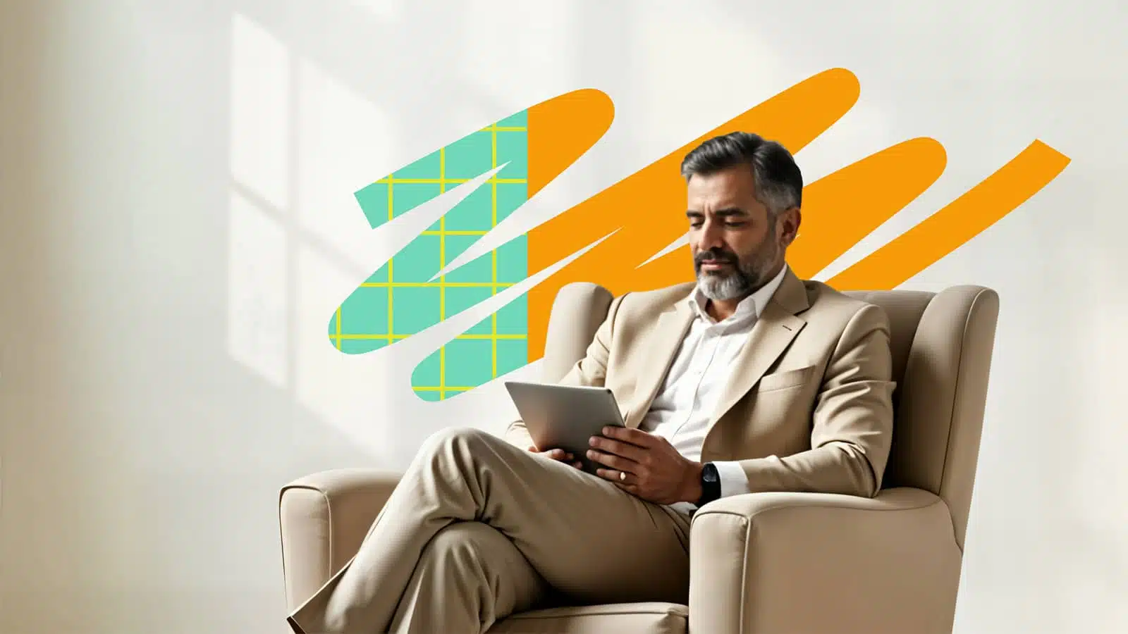 Business leader sitting in a chair wearing a suit and browsing his ipad