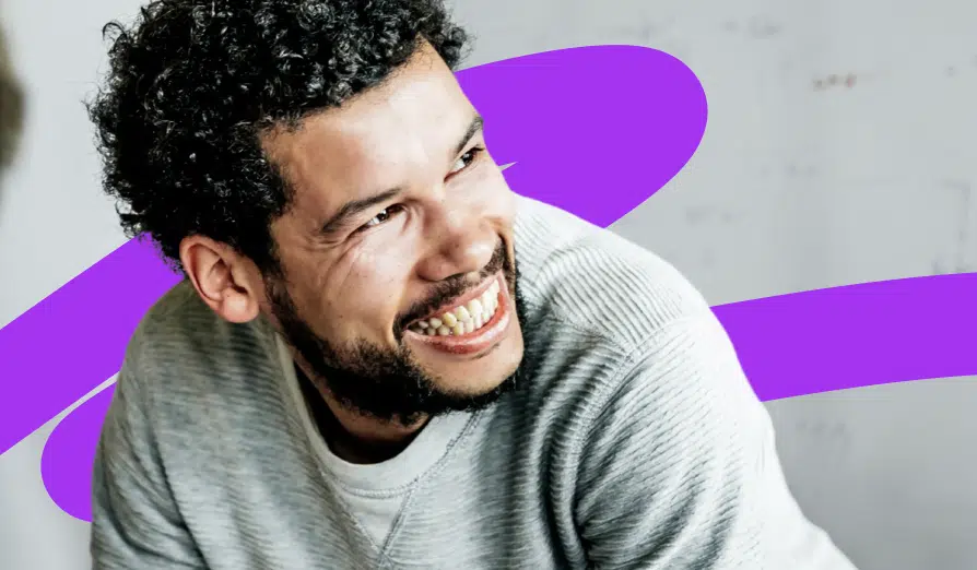 Man smiling and looking over his shoulder