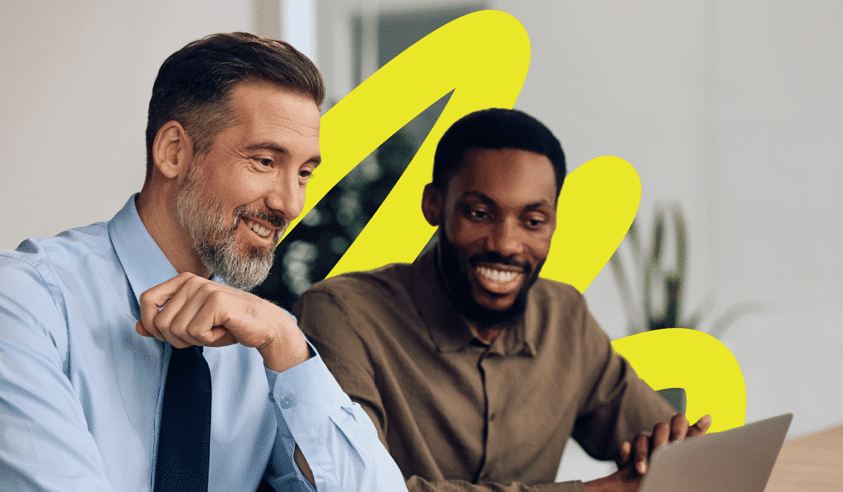 Two coworkers smiling and collaborating on a project