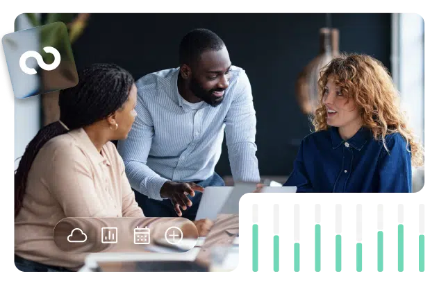 Coworkers smiling and chatting at their desk about work